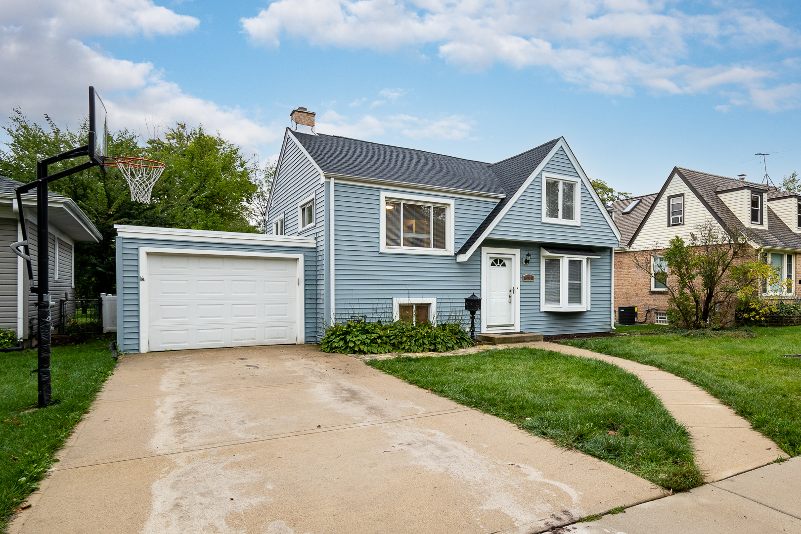 235 West Hickory Road Lombard, IL 60148 - Photo 2 of 23 a front view of a house with a yard and garage