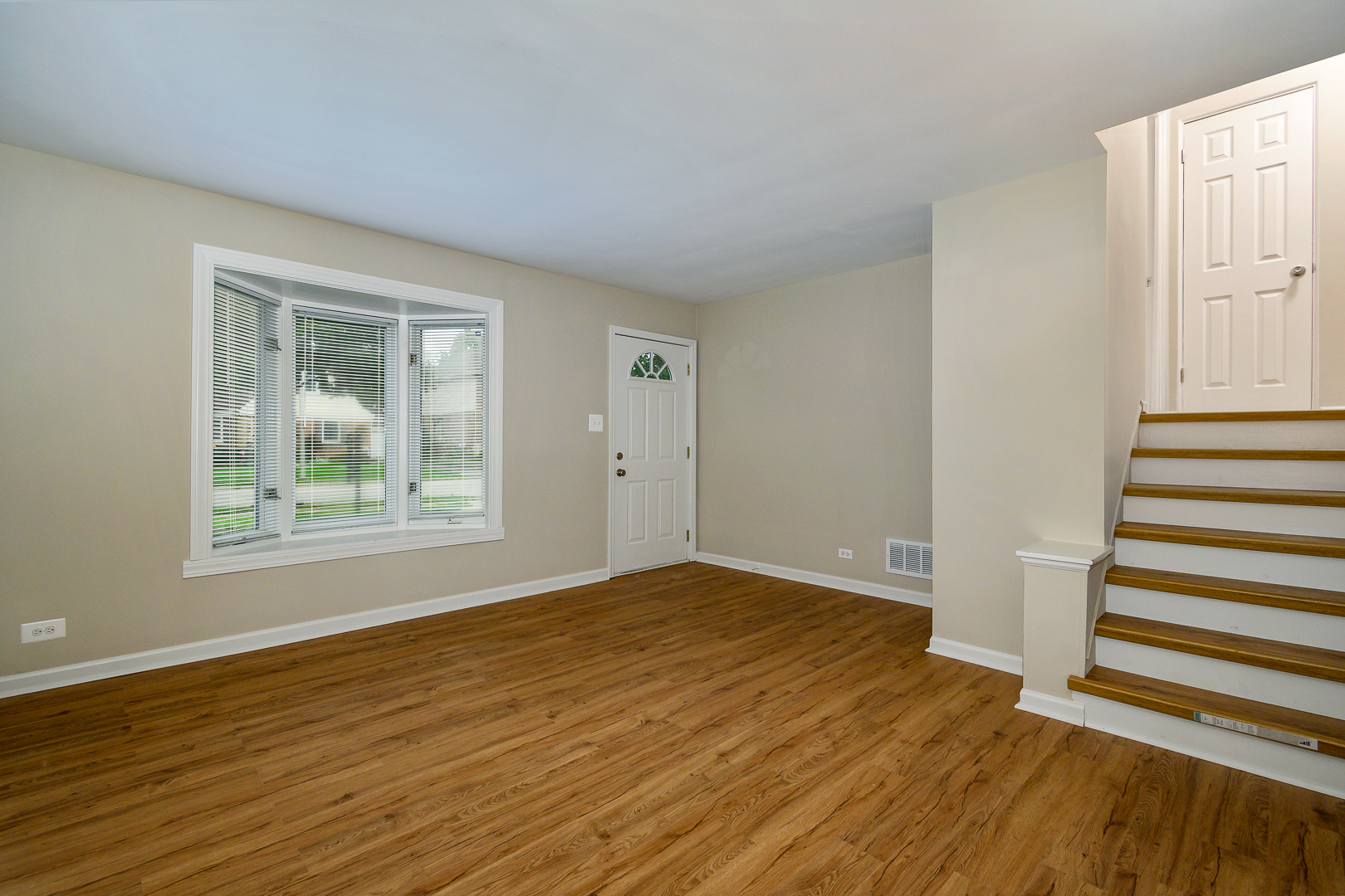 235 West Hickory Road Lombard, IL 60148 - Photo 3 of 23 a view of an empty room with wooden floor and a window