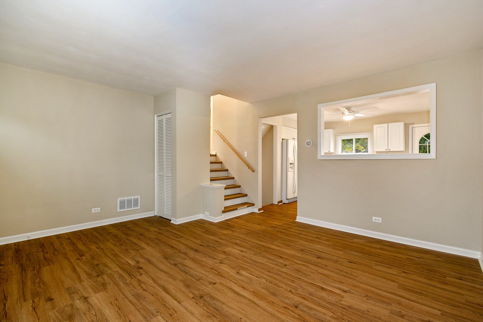 235 West Hickory Road Lombard, IL 60148 - Photo 4 of 23 a view of an empty room with wooden floor and stairs