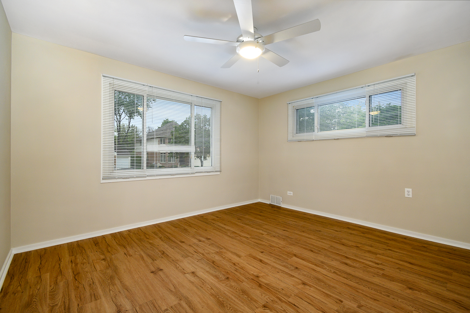 235 West Hickory Road Lombard, IL 60148 - Photo 10 of 23 a view of empty room with wooden floor and fan