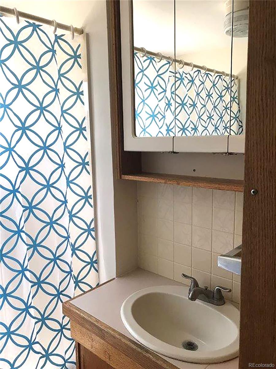 354 Neal Road Bailey, CO 80421 - Photo 13 of 19 a bathroom with a sink and a window