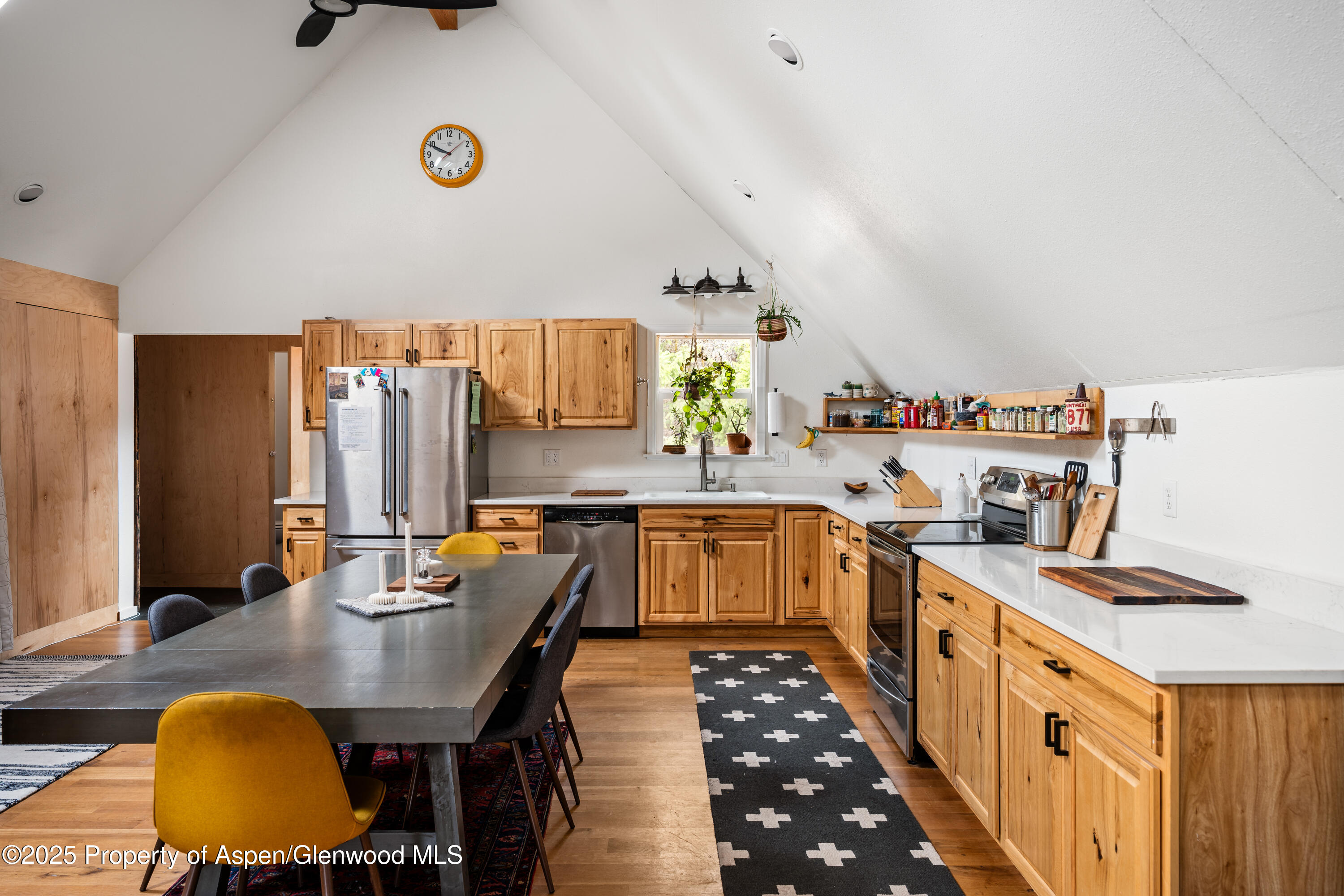 189 Ute Trail Carbondale, CO 81623 - Photo 33 of 76 a kitchen with stainless steel appliances a sink a stove top oven a chimney and a center island