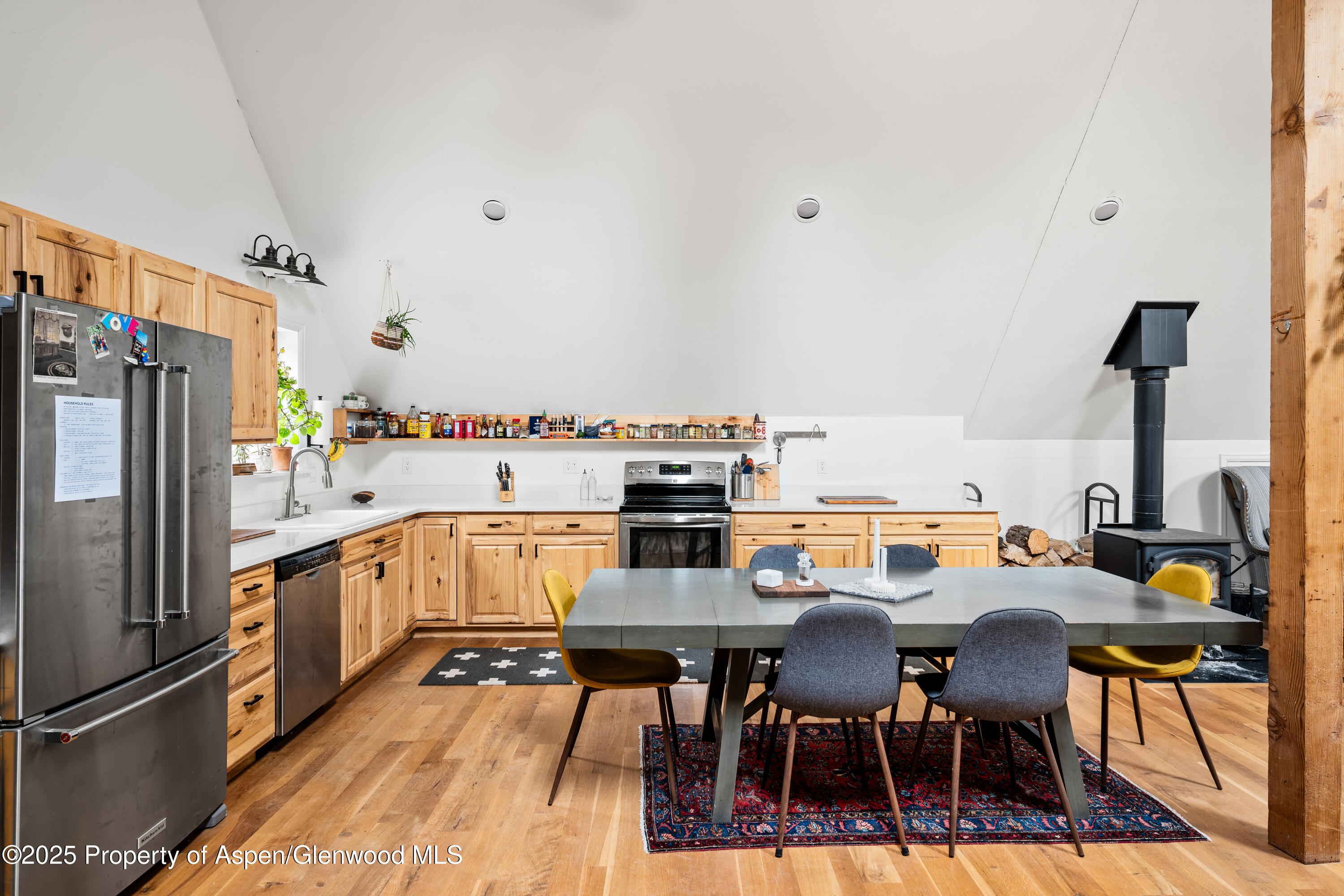 189 Ute Trail Carbondale, CO 81623 - Photo 34 of 76 a kitchen with stainless steel appliances a dining table chairs and refrigerator