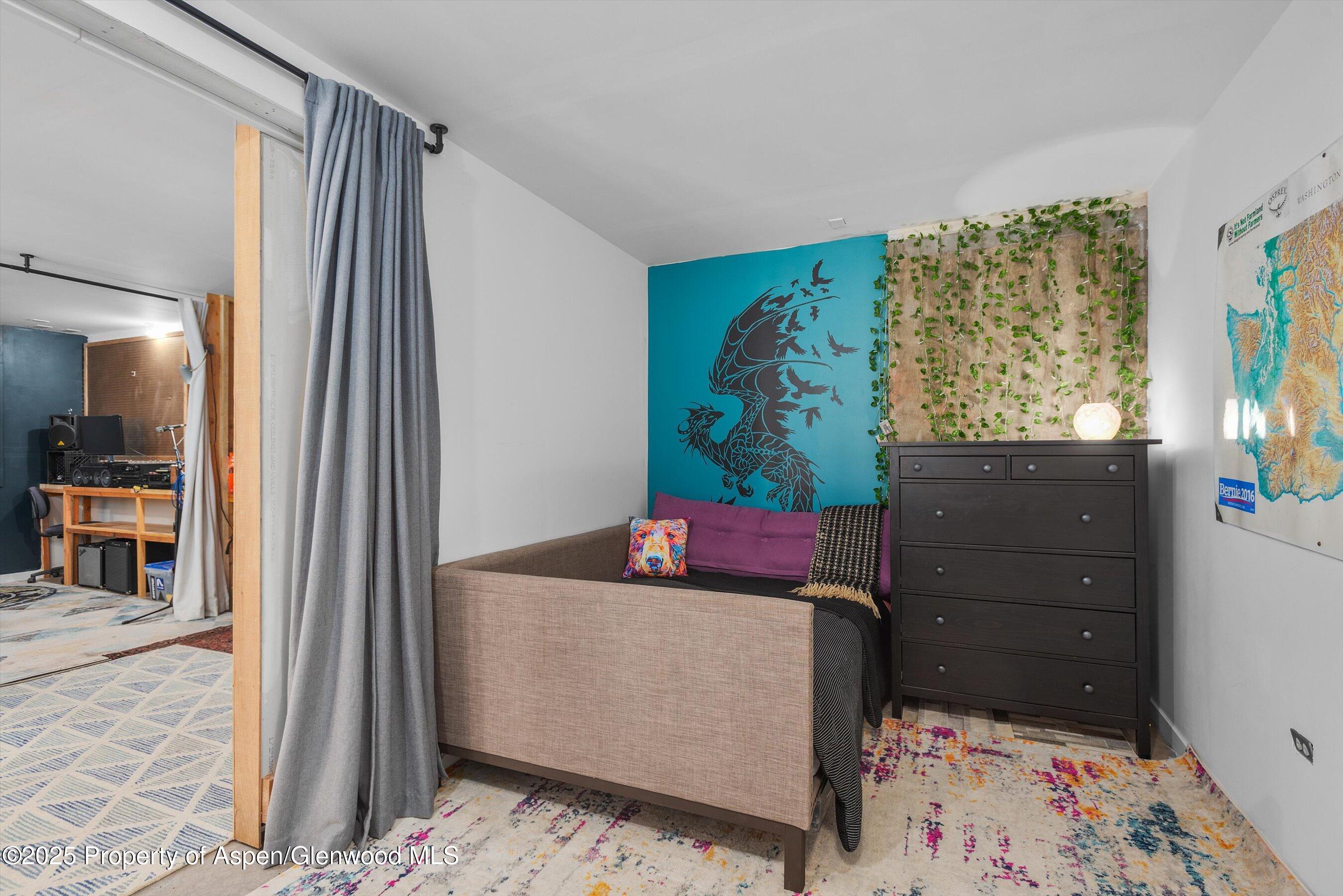 189 Ute Trail Carbondale, CO 81623 - Photo 59 of 76 a bedroom with a bed and wooden floor