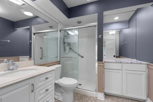 a bathroom with a sink a toilet and shower