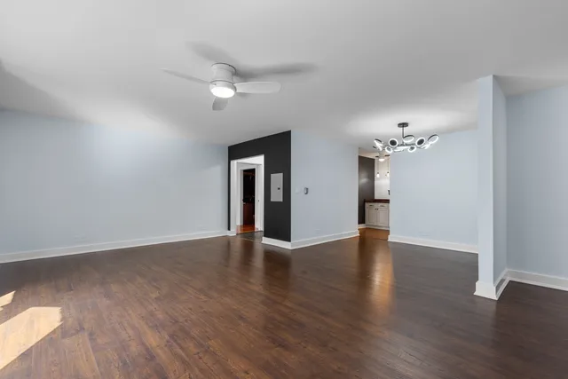 a view of an empty room with wooden floor