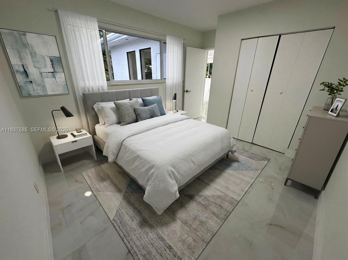 4501 Jefferson Street Hollywood, FL 33021 - Photo 11 of 15 a bedroom with a bed and a mirror