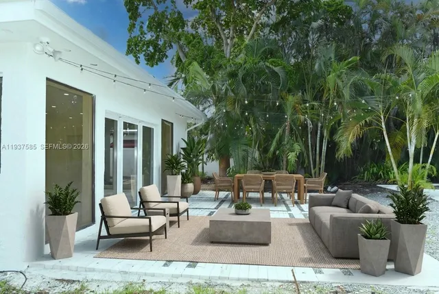 a patio with patio a couch and potted plants