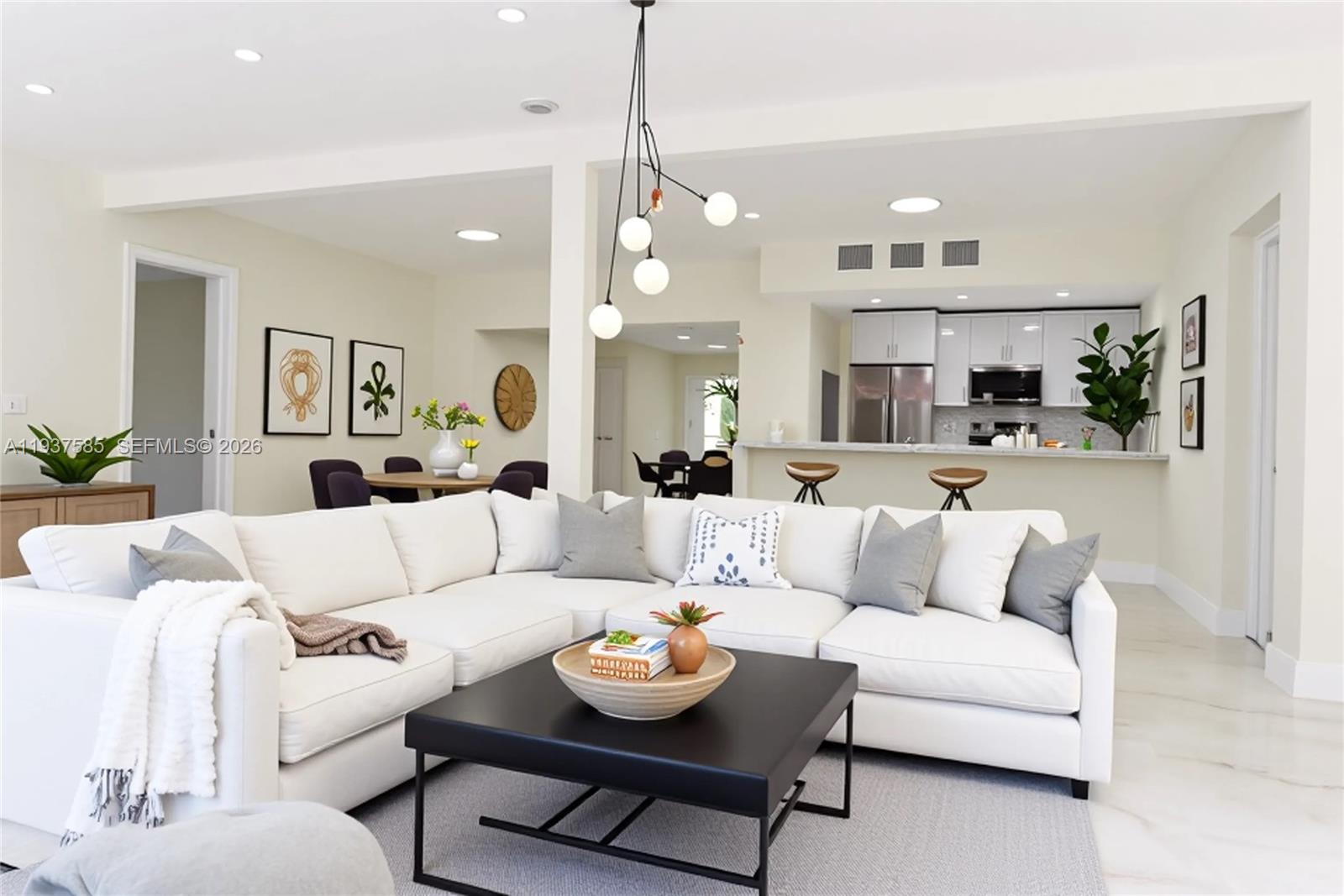 4501 Jefferson Street Hollywood, FL 33021 - Photo 2 of 15 a living room with furniture and a chandelier