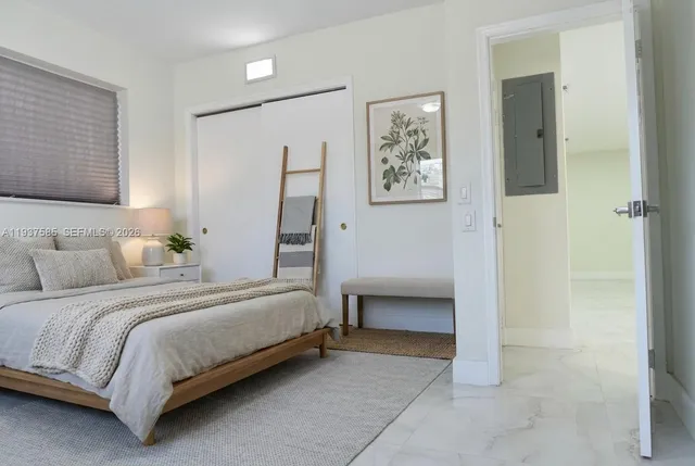 a bedroom with a bed and a view of bathroom