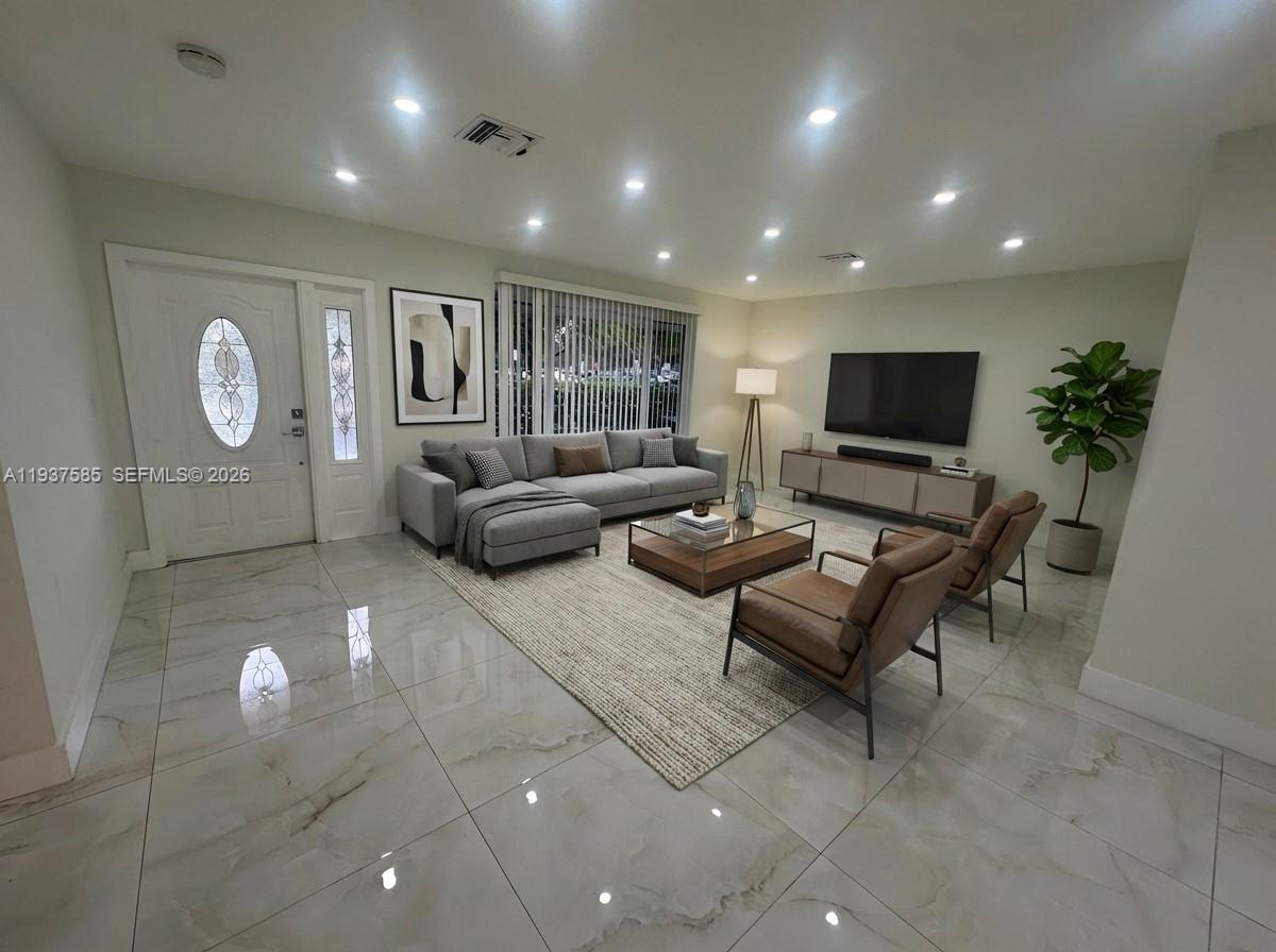 4501 Jefferson Street Hollywood, FL 33021 - Photo 10 of 15 a living room with furniture and a flat screen tv