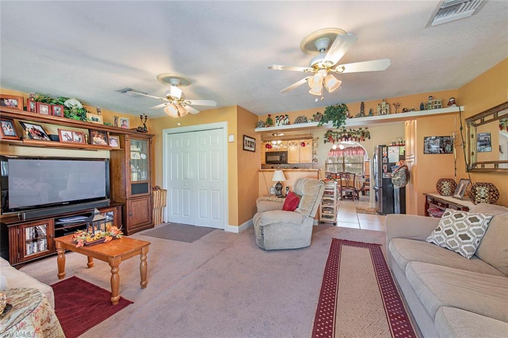 278 Sabal Palm Road Naples, FL 34114 - Photo 3 of 12 a living room with lots of furniture and a flat screen tv