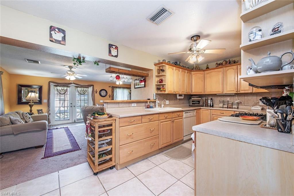 278 Sabal Palm Road Naples, FL 34114 - Photo 5 of 12 a kitchen with stainless steel appliances granite countertop a stove and cabinets