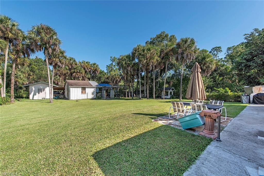 278 Sabal Palm Road Naples, FL 34114 - Photo 9 of 12 a view of a house with a yard and sitting area
