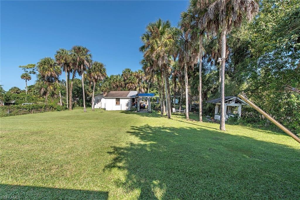 278 Sabal Palm Road Naples, FL 34114 - Photo 10 of 12 a view of a house with a yard