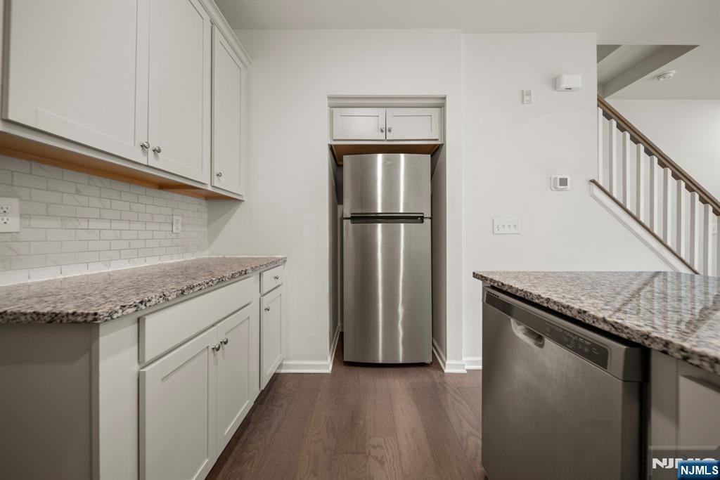 69 Arnold Drive, Unit 5810 Wood-Ridge, NJ 07075 - Photo 14 of 45 a kitchen with granite countertop a sink and a refrigerator