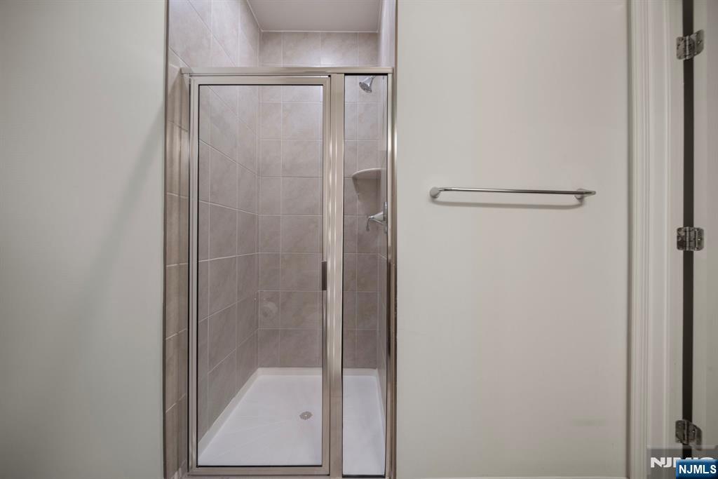 69 Arnold Drive, Unit 5810 Wood-Ridge, NJ 07075 - Photo 18 of 45 a bathroom with a glass shower door