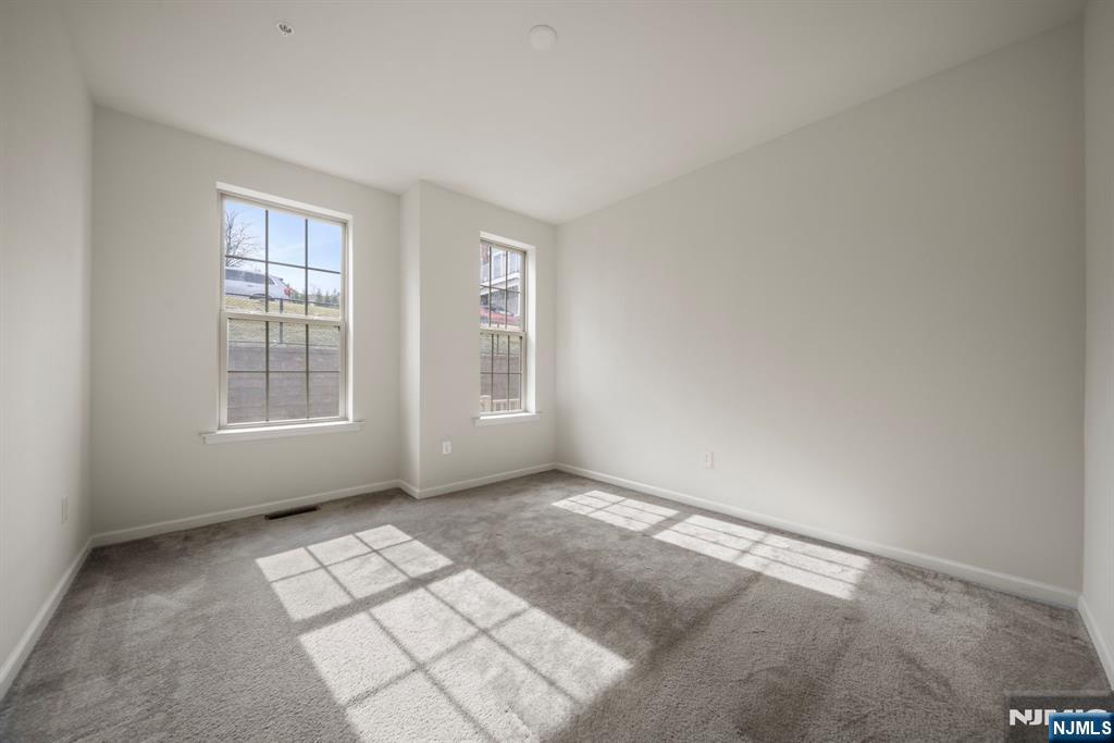 69 Arnold Drive, Unit 5810 Wood-Ridge, NJ 07075 - Photo 20 of 45 an empty room with windows