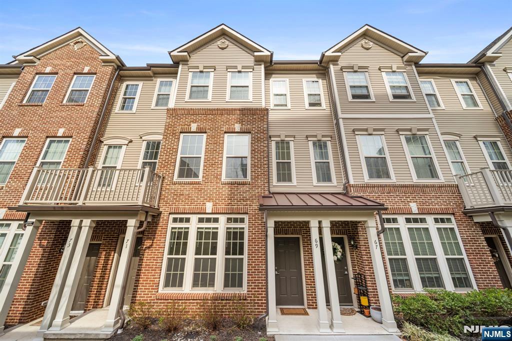 69 Arnold Drive, Unit 5810 Wood-Ridge, NJ 07075 - Photo 2 of 45 a front view of a residential apartment building