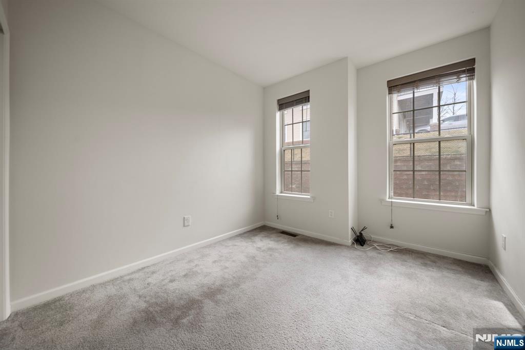 69 Arnold Drive, Unit 5810 Wood-Ridge, NJ 07075 - Photo 24 of 45 an empty room with windows