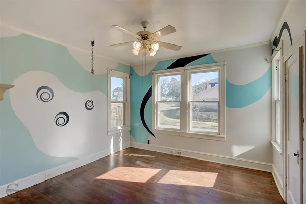 a view of an entryway with wooden floor and door