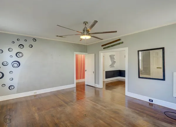 a view of an empty room with a ceiling fan