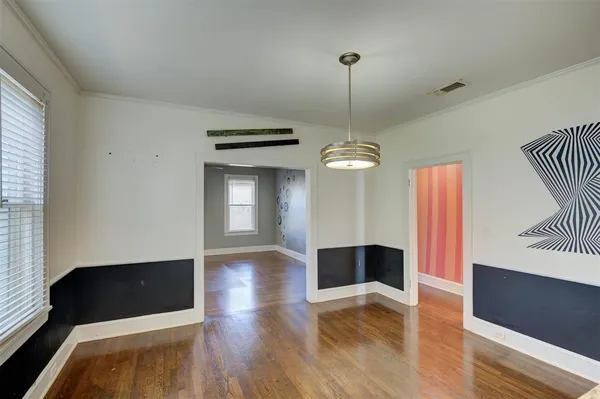 a view of a livingroom with wooden floor and staircase