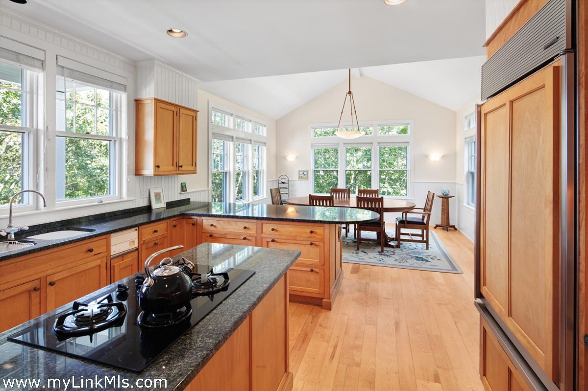 78 Hammett Road Chilmark, MA 02535 - Photo 32 of 53 a kitchen with stainless steel appliances granite countertop a stove a sink and a dining table