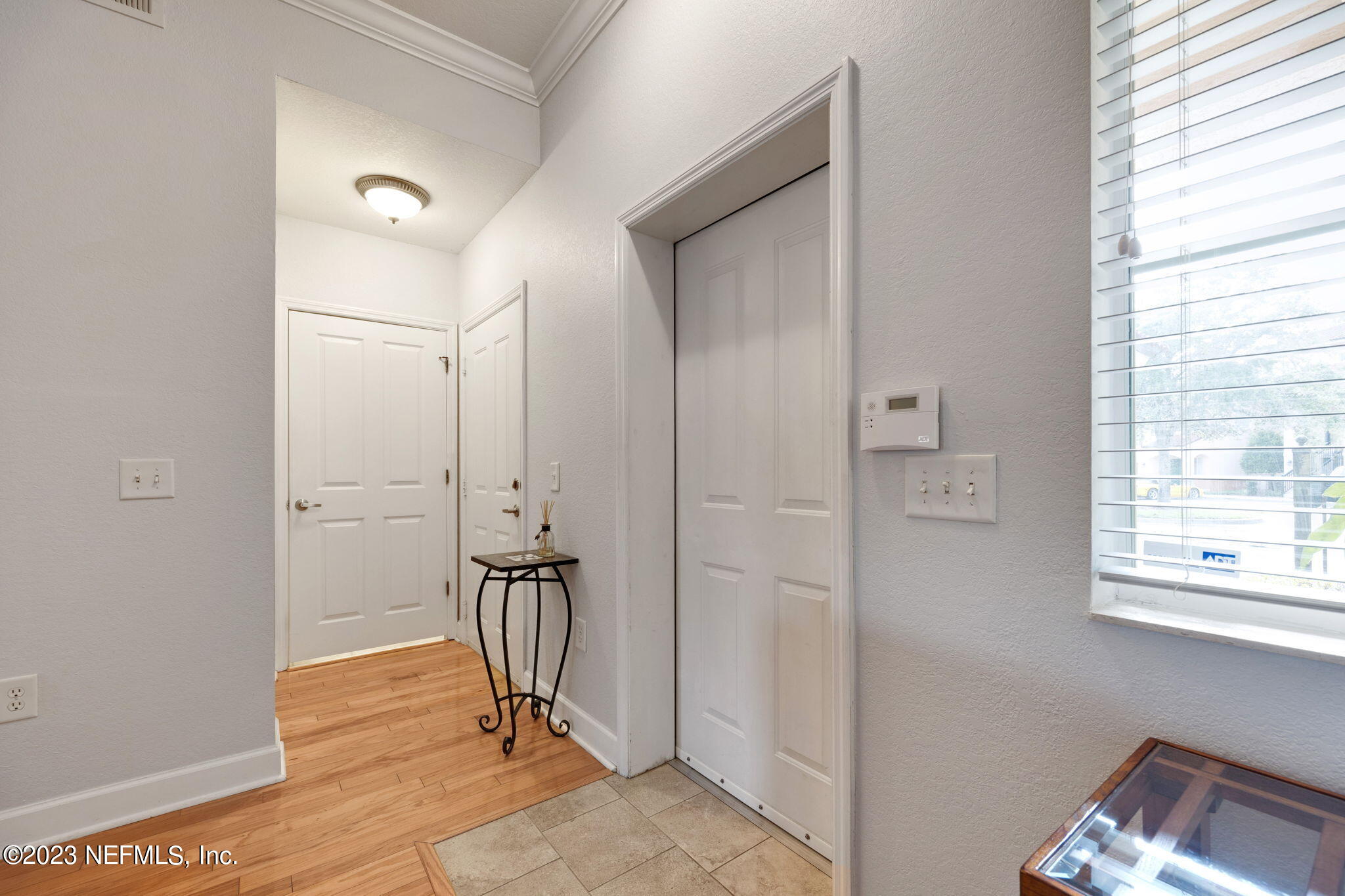 9745 Touchton Road, Unit 3003 Jacksonville, FL 32246 - Photo 3 of 44 a view of a hallway with wooden floor and a bathroom