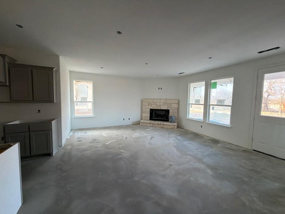 1253 Sabine River Lane Springtown, TX 76082 - Photo 4 of 8 a view of empty room with a fireplace and window