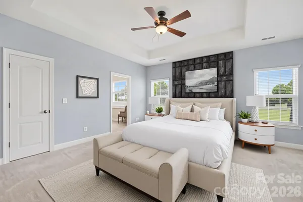a bedroom with a bed couch and window