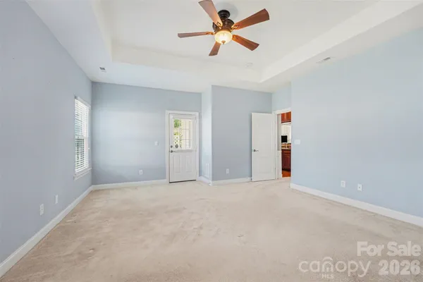an empty room with closet and windows