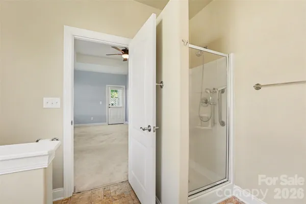 a bathroom with a shower and a sink