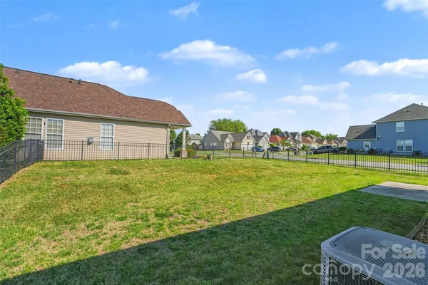 a view of a house with a yard and sitting area