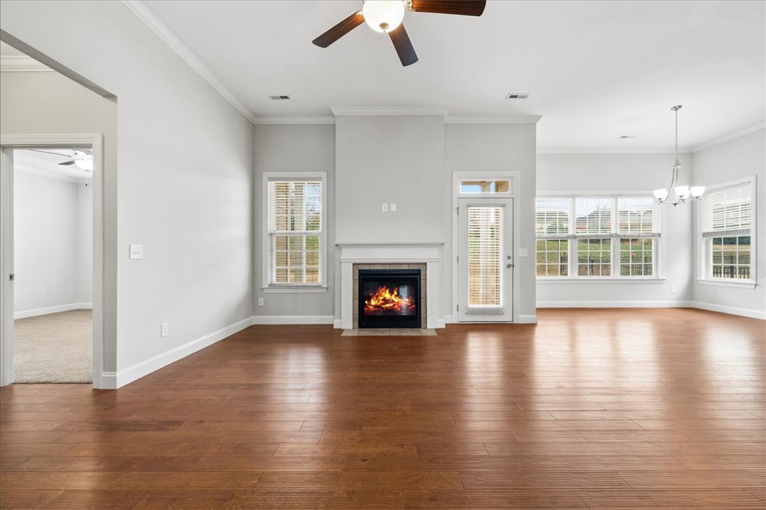 102 Ripplestone Way Anderson, SC 29621 - Photo 5 of 39 A welcoming living space boasts rich hardwood floors and a cozy fireplace, perfect for relaxation.