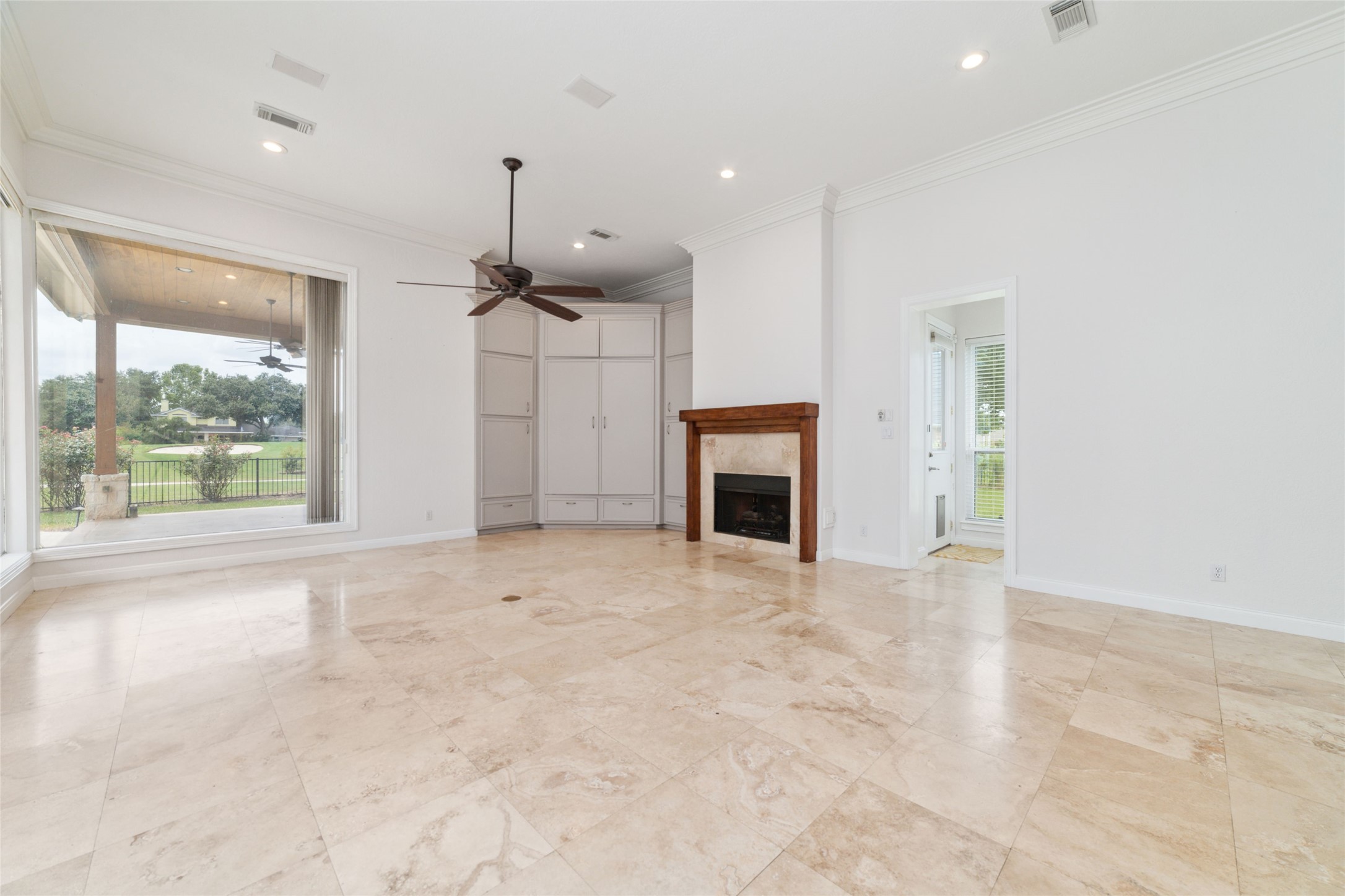 32610 Whitburn Trail Fulshear, TX 77441 - Photo 21 of 49 a view of an empty room with a fireplace and a window