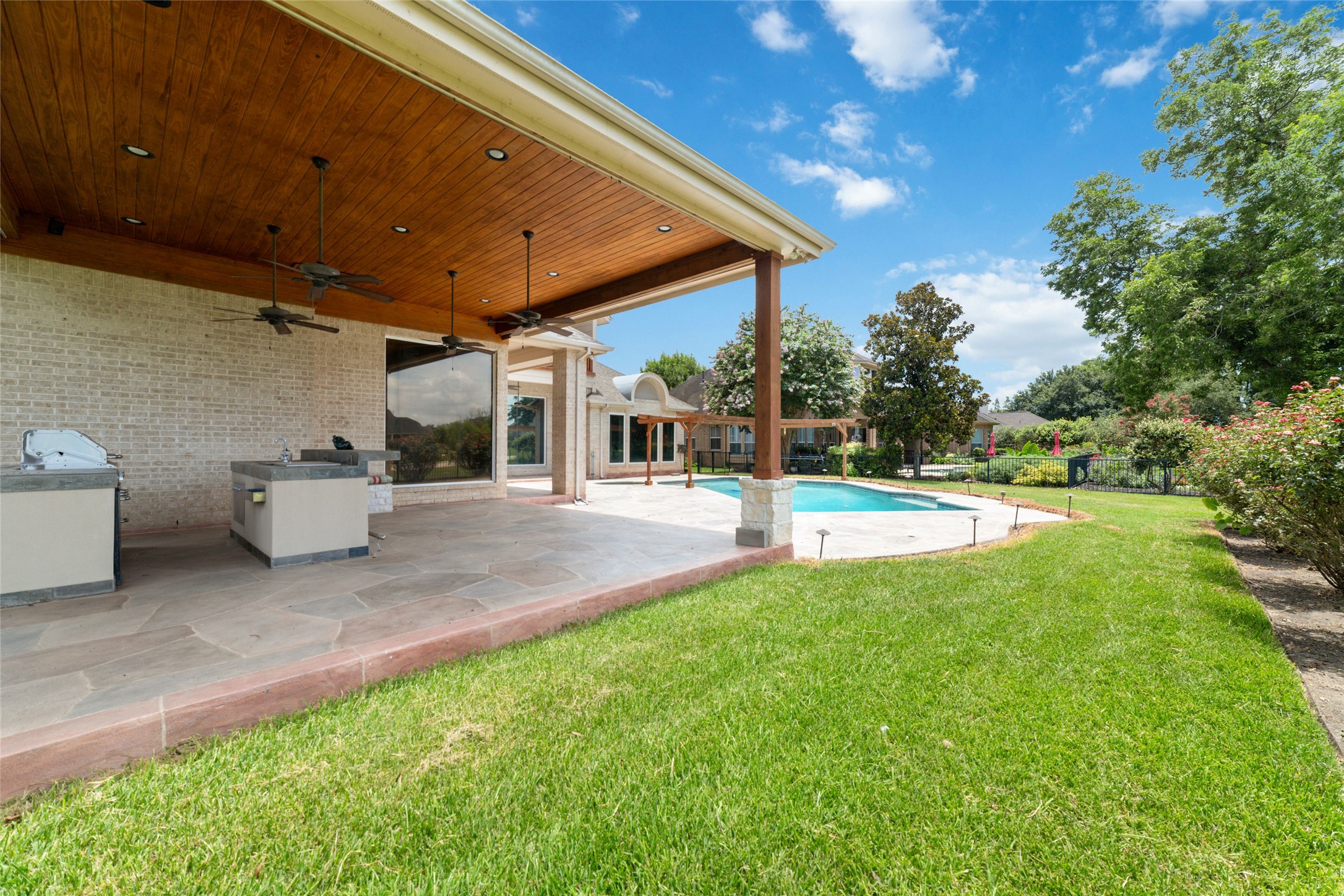 32610 Whitburn Trail Fulshear, TX 77441 - Photo 45 of 49 a view of a patio with a table and chairs under an umbrella