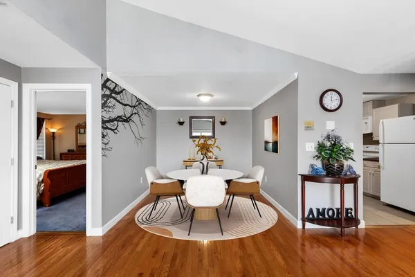 a view of a dining room with furniture and wooden floor