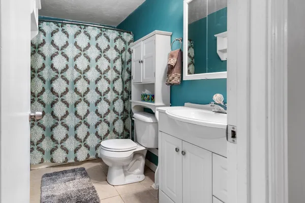 a bathroom with a sink toilet and a mirror