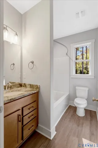 a bathroom with a granite countertop sink toilet and bathtub