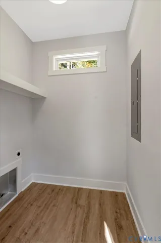 a view of a room with wooden floor