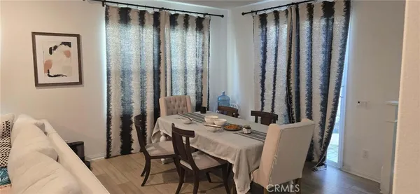 a view of a dining room with furniture and window