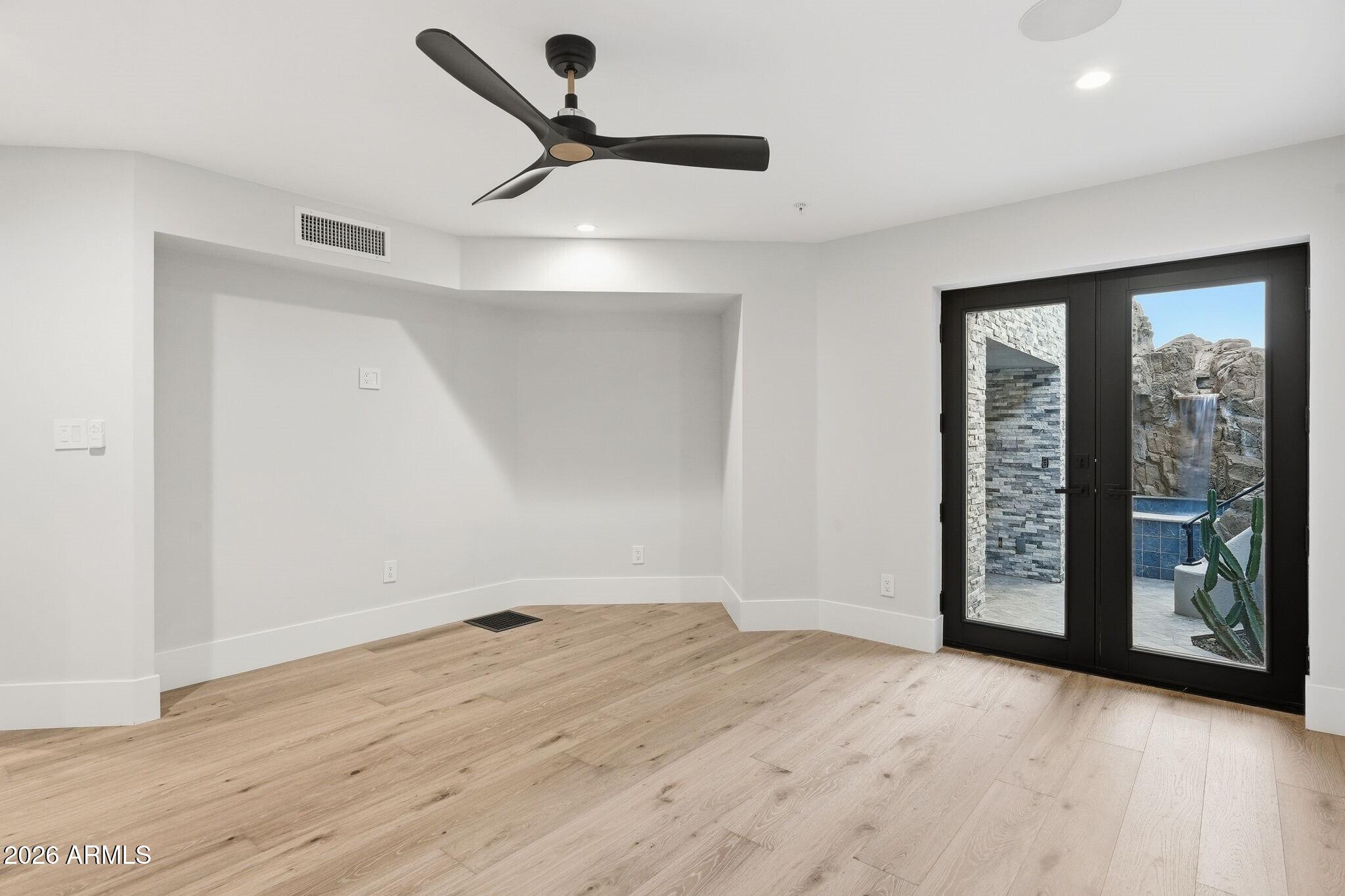 7475 East Gainey Ranch Road, Unit 7 Scottsdale, AZ 85258 - Photo 58 of 77 a view of an empty room with wooden floor and a window