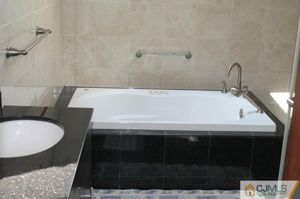 10 Greenwich Road Edison, NJ 08820 - Photo 16 of 25 a bathroom with a sink and a bathtub