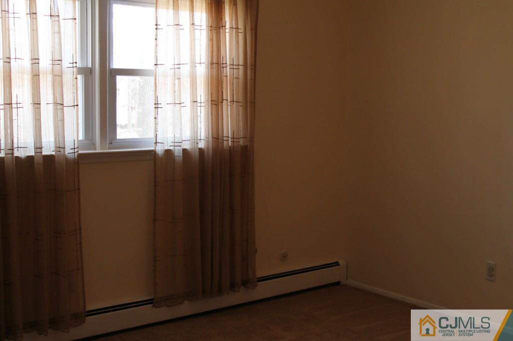 10 Greenwich Road Edison, NJ 08820 - Photo 19 of 25 a view of a closet area with wooden floor