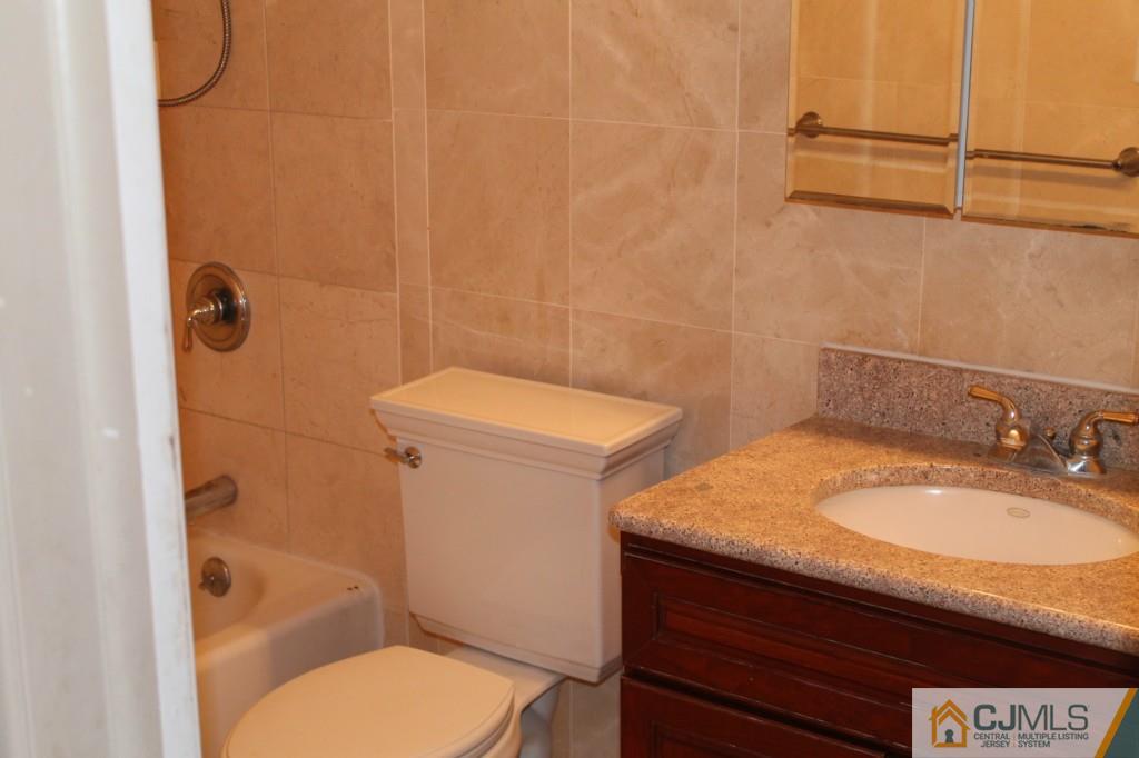 10 Greenwich Road Edison, NJ 08820 - Photo 20 of 25 a bathroom with a granite countertop toilet and a sink