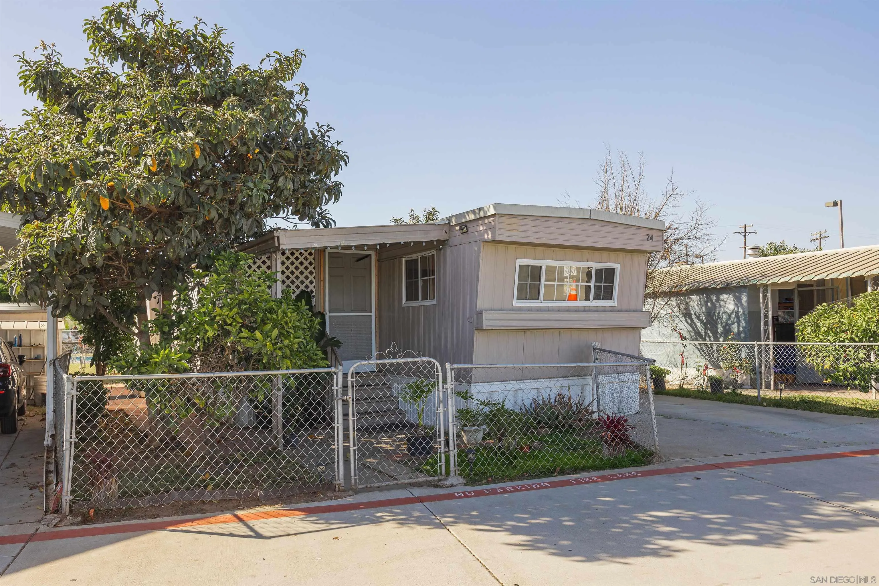 1023 Outer Road, Unit 24 San Diego, CA 92154 - Photo 4 of 16 a front view of a house with garden