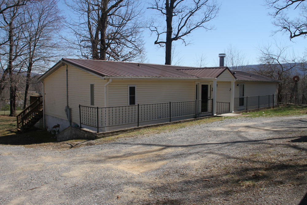 1084 Treasure Lane Blue Ridge, VA 24064 - Photo 2 of 37 a view of a white house with a large tree