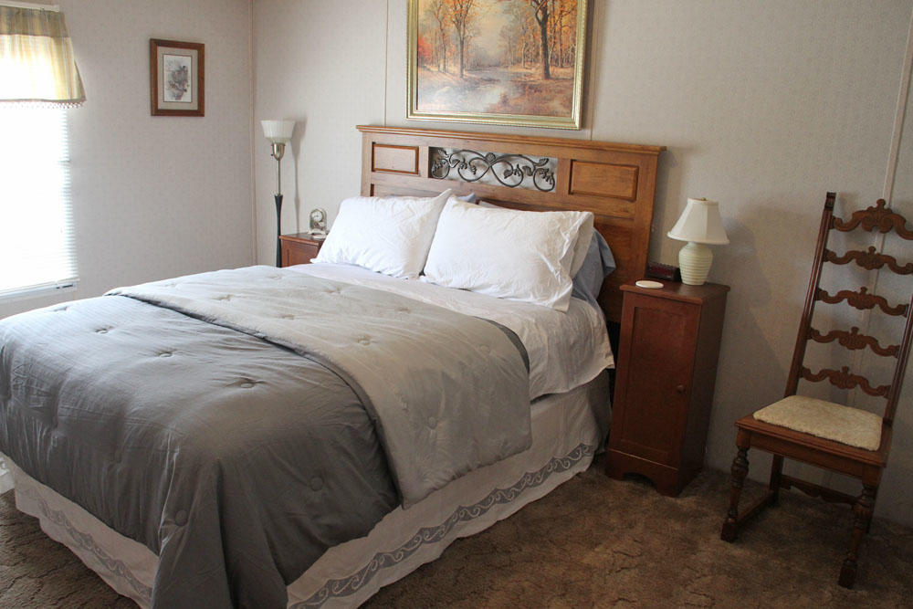 1084 Treasure Lane Blue Ridge, VA 24064 - Photo 22 of 37 a bedroom with a bed and wooden floor