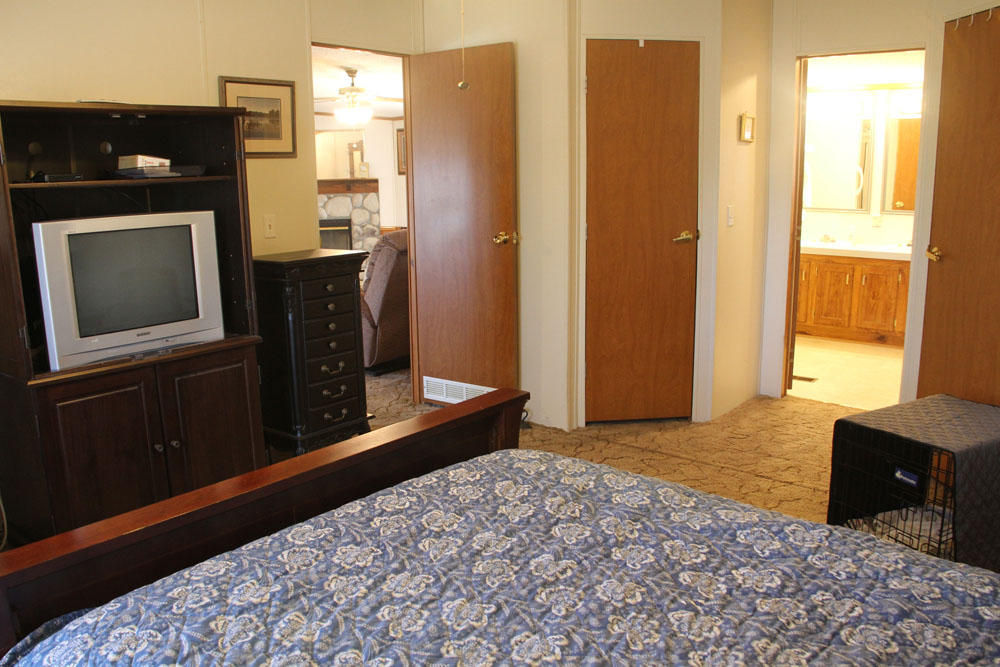 1084 Treasure Lane Blue Ridge, VA 24064 - Photo 28 of 37 a bedroom with a bed and wooden floor